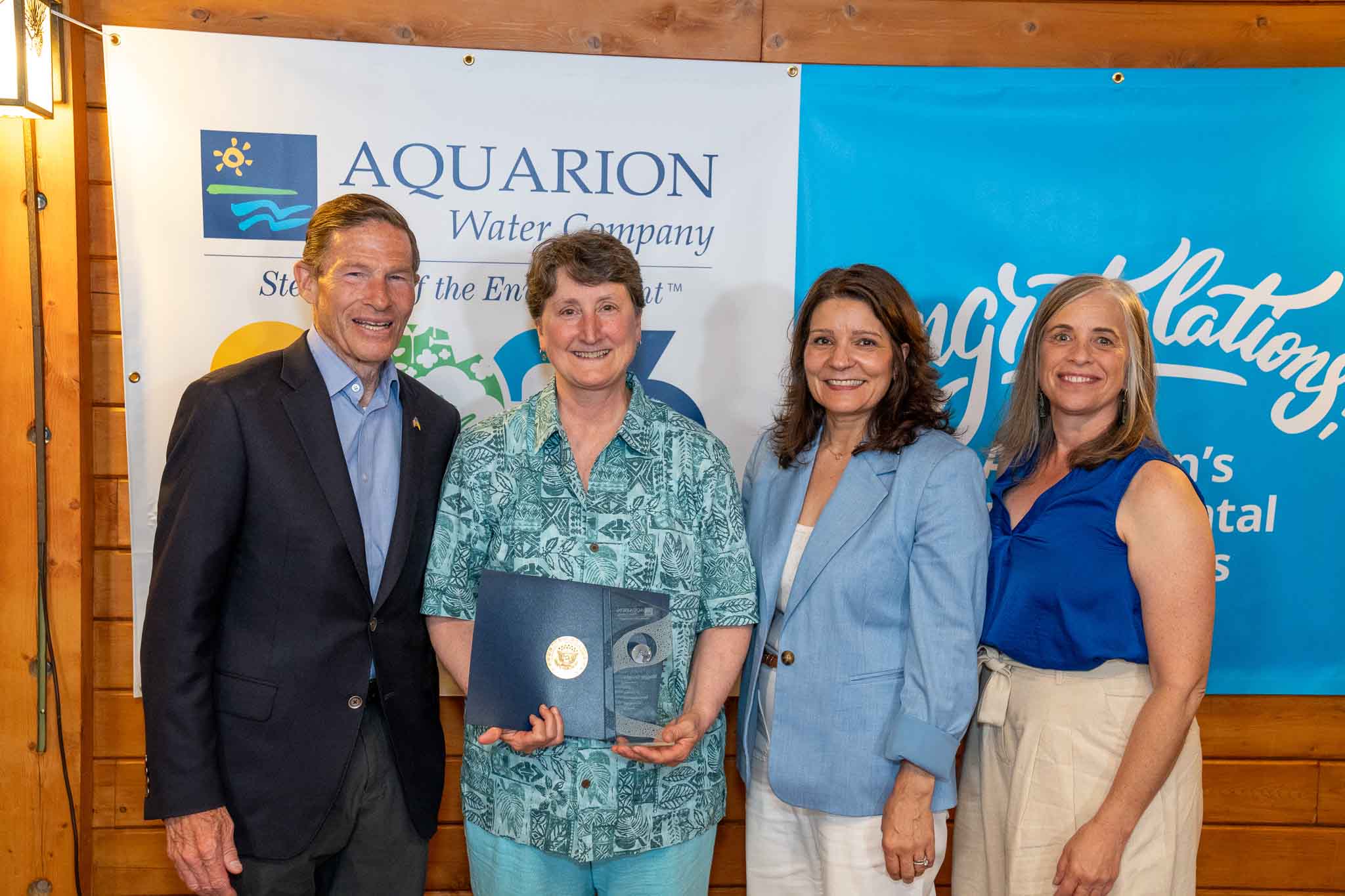 adult-winner PHOTO (left to right): U.S. Senator Richard Blumenthal; Maggie Favretti, Co-Founder of the Alliance for the Mystic River Watershed; Lucy Teixeira, President of Aquarion Water Company; and Carolyn Giampe, Director of Watershed & Environmental Management at Aquarion Water Company.