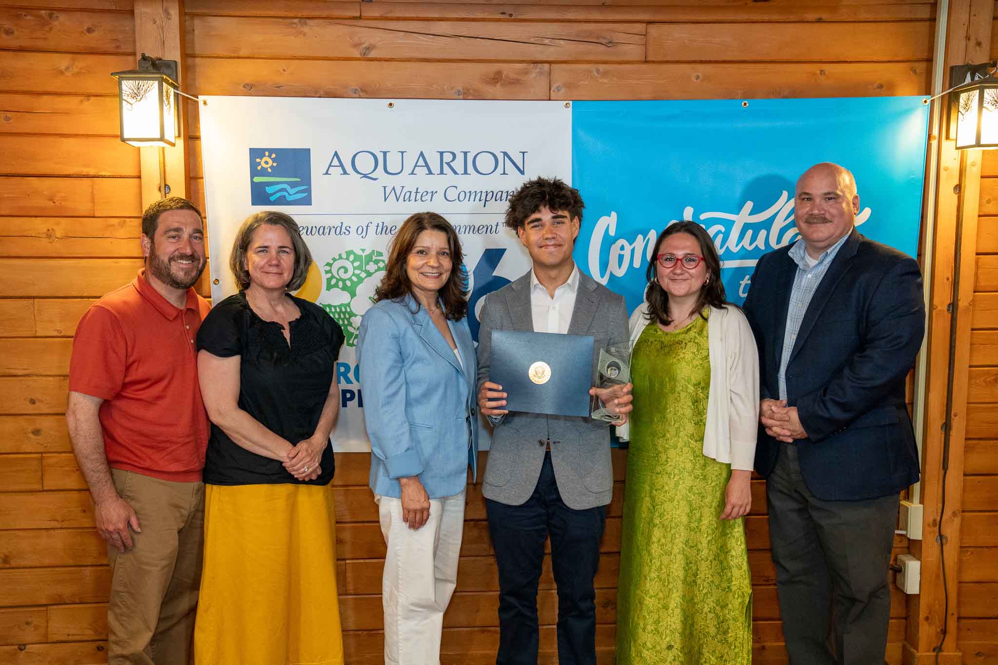student-winner PHOTO: Lucy Teixeira, President of Aquarion Water Company; Peter Fazekas, Director of Corporate Communications at Aquarion Water Company; and Tomás Gutiérrez and his family